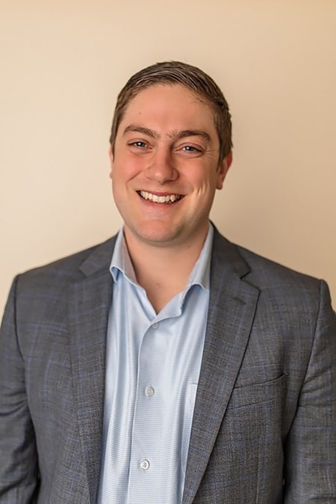 Smiling man in business attire.