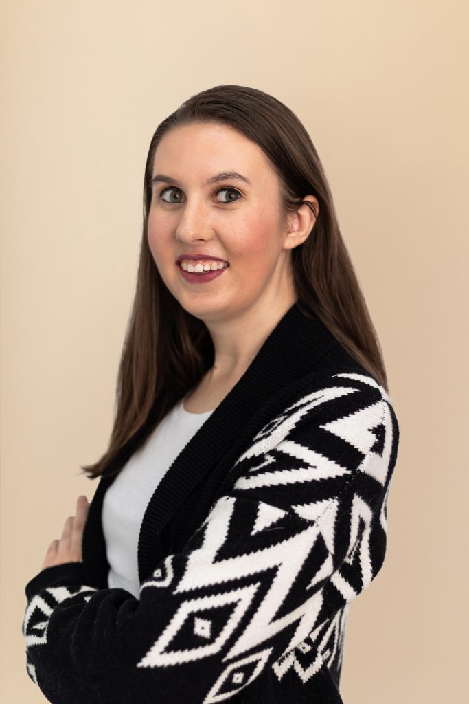 Woman in patterned cardigan smiling