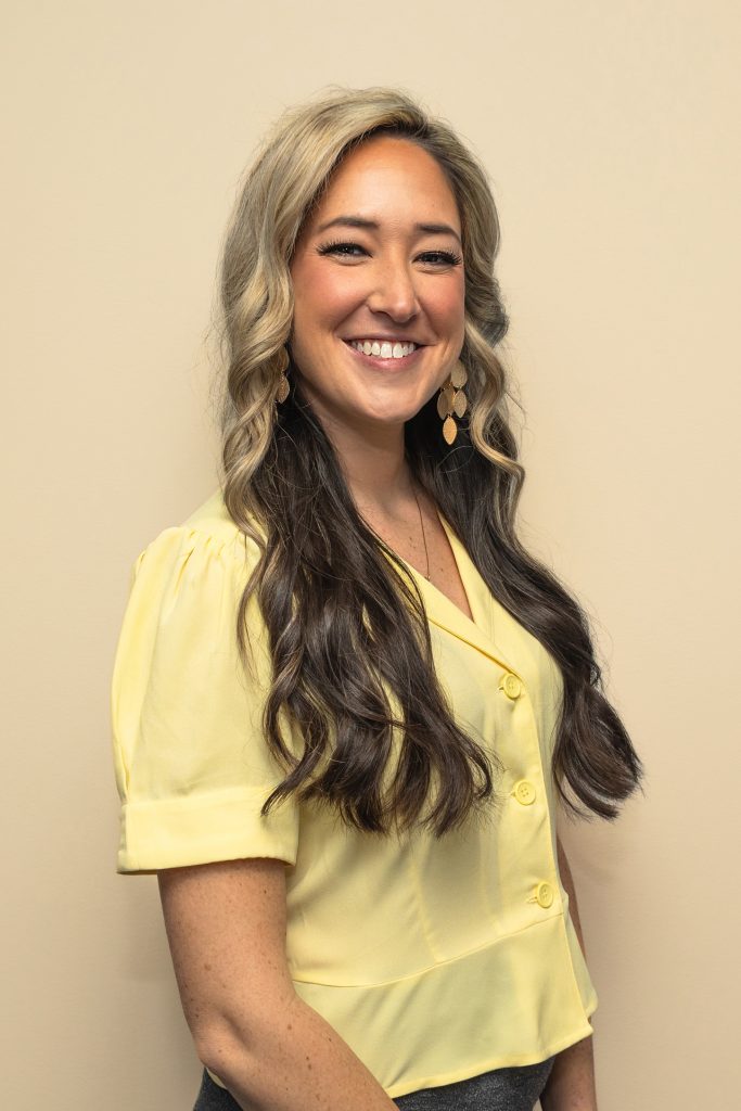Smiling woman in yellow blouse